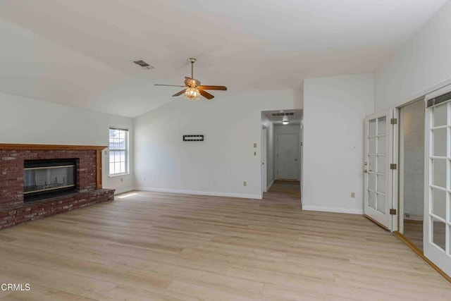 4120 Abbott Dr, Bakersfield, CA 93312 - unfurnished living room featuring french doors, vaulted ceiling, a ceiling fan, light wood-style floors, and a fireplace