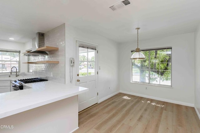 4120 Abbott Dr, Bakersfield, CA 93312 - kitchen featuring wall chimney range hood, healthy amount of natural light, stainless steel gas stove, and recessed lighting