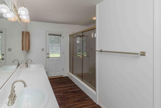 4120 Abbott Dr, Bakersfield, CA 93312 - bathroom with a shower stall, wood finished floors, double vanity, and a chandelier