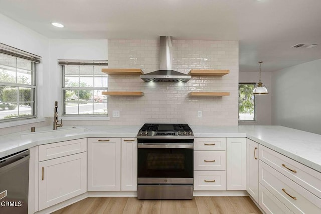 4120 Abbott Dr, Bakersfield, CA 93312 - kitchen with appliances with stainless steel finishes, wall chimney range hood, open shelves, light countertops, and recessed lighting