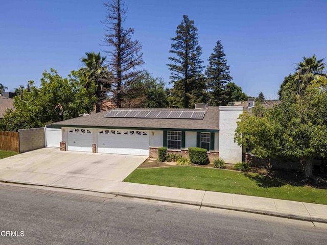 4120 Abbott Dr, Bakersfield, CA 93312 - ranch-style house with an attached garage, solar panels, driveway, stucco siding, and brick siding