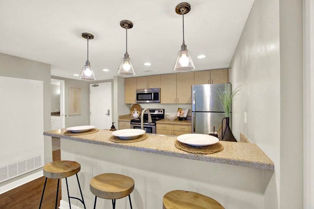425 W Beech St Unit 417, San Diego, CA 92101 - kitchen with stainless steel appliances, recessed lighting, dark wood-style floors, a breakfast bar, and light brown cabinets