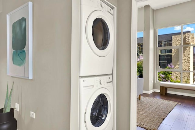 425 W Beech St Unit 417, San Diego, CA 92101 - laundry room with stacked washer and clothes dryer, healthy amount of natural light, and dark wood finished floors