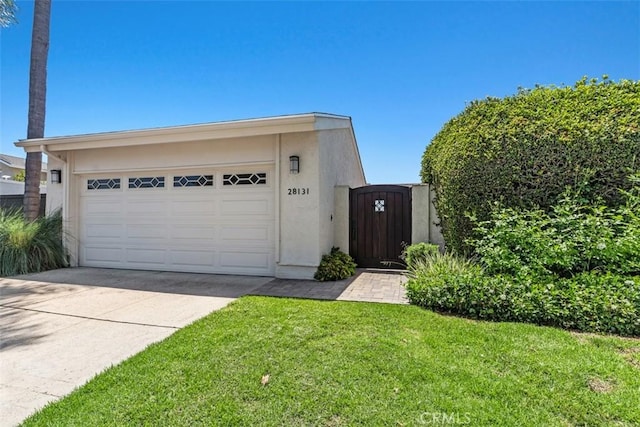 28131 Rubicon Ct, Laguna Niguel, CA 92677 - view of front of house featuring a garage, stucco siding, driveway, a gate, and a front lawn