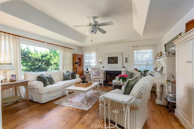 869 Phillips St, Vista, CA 92083 - living area featuring a raised ceiling, plenty of natural light, a ceiling fan, and wood finished floors