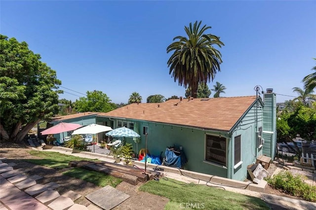869 Phillips St, Vista, CA 92083 - rear view of property featuring stucco siding and a chimney