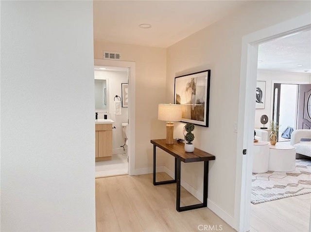 23615 Tellgate Dr, Diamond Bar, CA 91765 - corridor featuring light wood-type flooring and baseboards