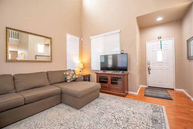 2414 Falcon Valley Dr, Chula Vista, CA 91914 - living area featuring wood finished floors, a towering ceiling, and recessed lighting