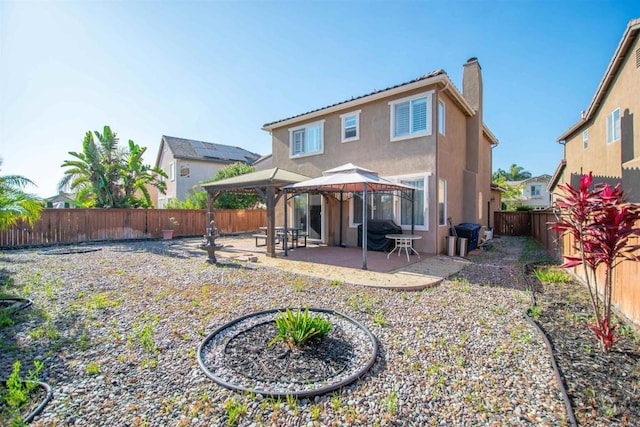 2414 Falcon Valley Dr, Chula Vista, CA 91914 - rear view of house with a gazebo, stucco siding, a chimney, a patio, and a fenced backyard
