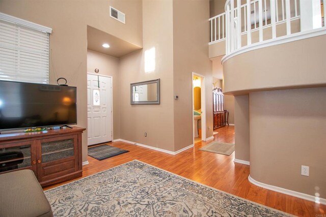 2414 Falcon Valley Dr, Chula Vista, CA 91914 - living area with a high ceiling, wood finished floors, and arched walkways