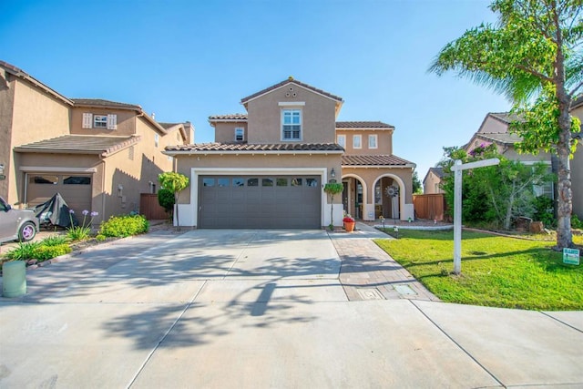 2414 Falcon Valley Dr, Chula Vista, CA 91914 - mediterranean / spanish house featuring stucco siding, concrete driveway, a garage, and a tile roof