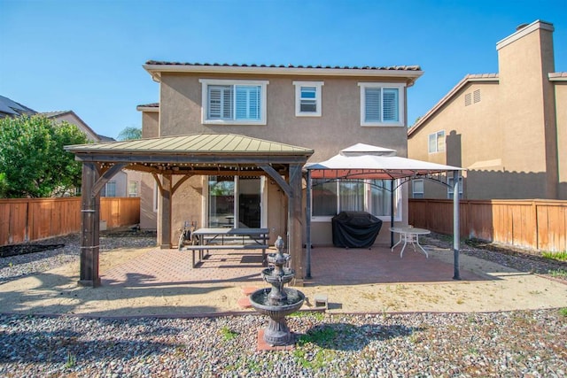 2414 Falcon Valley Dr, Chula Vista, CA 91914 - rear view of house with a gazebo, stucco siding, a patio area, and a fenced backyard