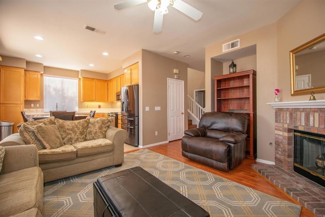 2414 Falcon Valley Dr, Chula Vista, CA 91914 - living room with light wood-style flooring, a ceiling fan, stairs, a fireplace, and recessed lighting