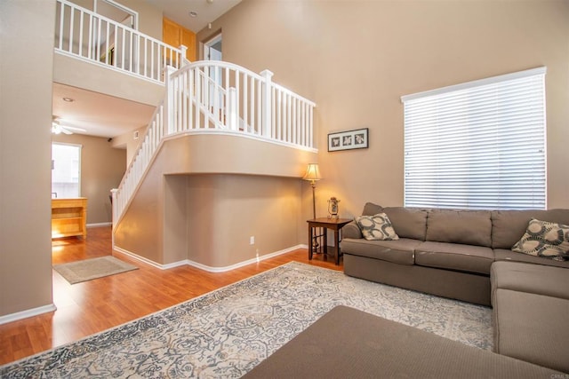 2414 Falcon Valley Dr, Chula Vista, CA 91914 - living room featuring wood finished floors, a towering ceiling, stairway, and a ceiling fan