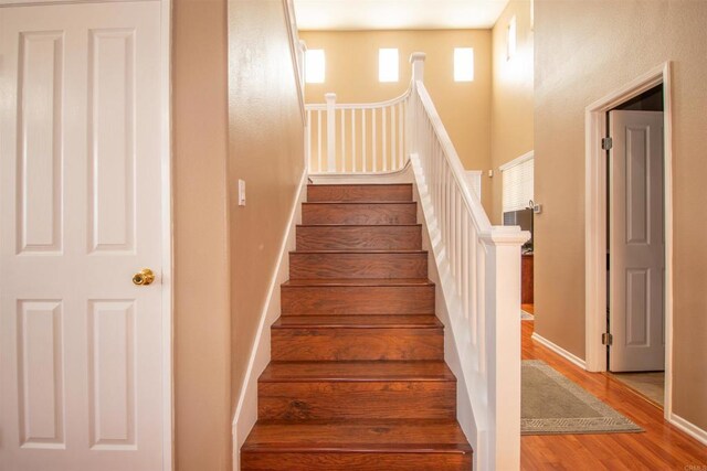 2414 Falcon Valley Dr, Chula Vista, CA 91914 - stairs featuring wood finished floors and a towering ceiling