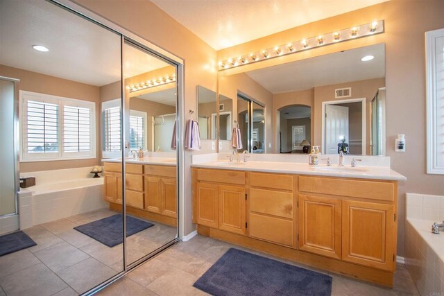 2414 Falcon Valley Dr, Chula Vista, CA 91914 - bathroom with double vanity, a garden tub, a shower with door, and tile patterned floors