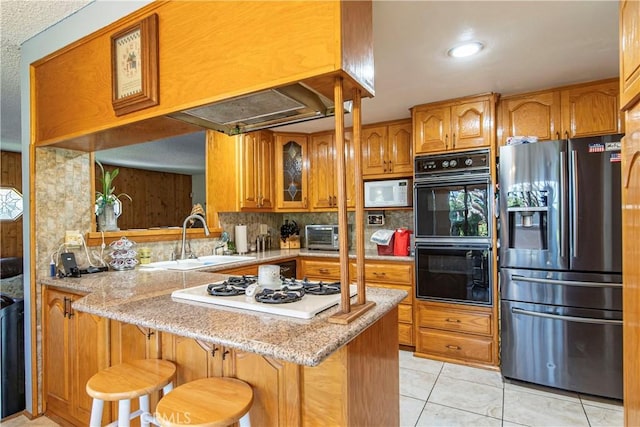 3032 Pietro Dr, Hacienda Heights, CA 91745 - kitchen with white appliances, brown cabinetry, tasteful backsplash, light tile patterned floors, and light stone countertops