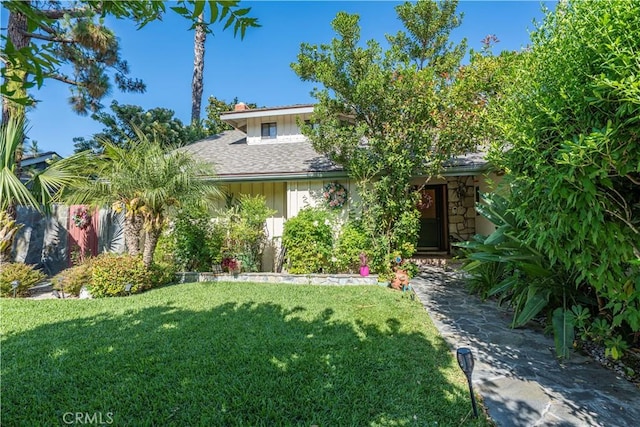 3032 Pietro Dr, Hacienda Heights, CA 91745 - view of front of property featuring a front yard, board and batten siding, stone siding, a chimney, and roof with shingles