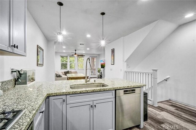 17035 Independence Way, Yorba Linda, CA 92886 - kitchen featuring stainless steel appliances, a peninsula, dark wood finished floors, a ceiling fan, and light stone counters