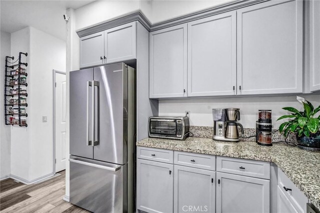 17035 Independence Way, Yorba Linda, CA 92886 - kitchen with high end refrigerator, light wood finished floors, and light stone countertops