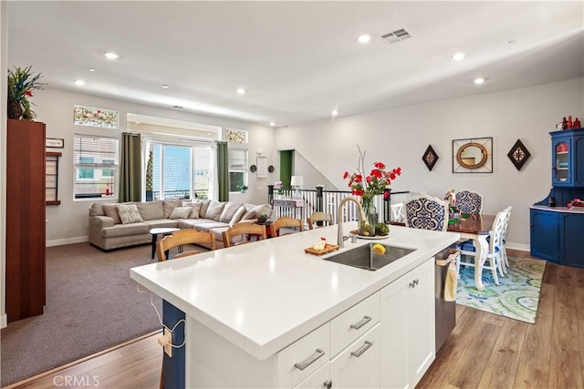 26957 Winding Trail Ct, Valencia, CA 91381 - kitchen with light countertops, light wood-style flooring, recessed lighting, open floor plan, and a kitchen island with sink