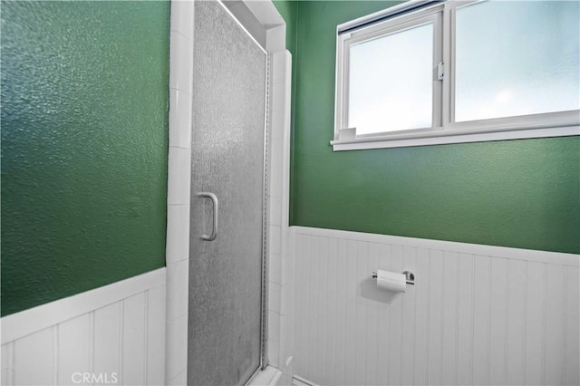 44055 Elm Ave, Lancaster, CA 93534 - full bathroom featuring a wainscoted wall, a stall shower, and a textured wall