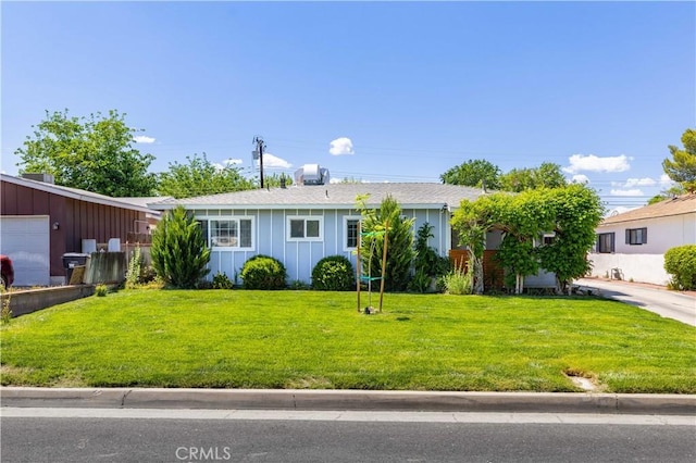 44055 Elm Ave, Lancaster, CA 93534 - ranch-style home with board and batten siding and a front yard