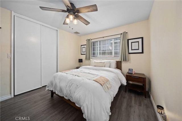 44055 Elm Ave, Lancaster, CA 93534 - bedroom featuring dark wood-type flooring, a closet, and ceiling fan