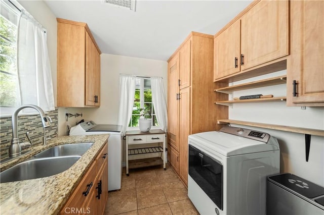 44055 Elm Ave, Lancaster, CA 93534 - laundry room featuring cabinet space, independent washer and dryer, and light tile patterned floors