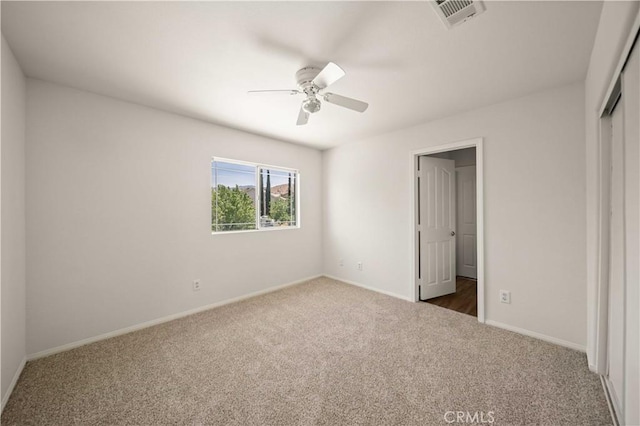 40225 Watford Way, Palmdale, CA 93551 - unfurnished bedroom with dark carpet, a closet, and a ceiling fan