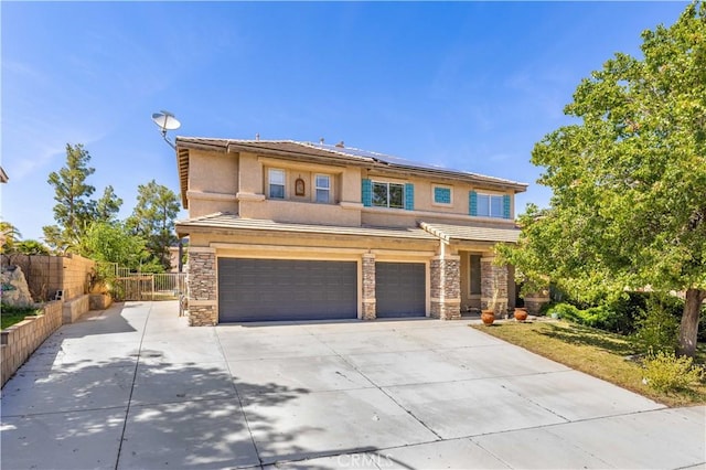 40225 Watford Way, Palmdale, CA 93551 - view of front of house featuring a garage, stone siding, solar panels, stucco siding, and driveway
