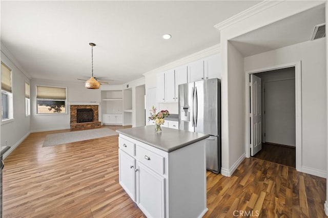 40225 Watford Way, Palmdale, CA 93551 - kitchen featuring stainless steel fridge, a fireplace, ceiling fan, white cabinetry, and recessed lighting