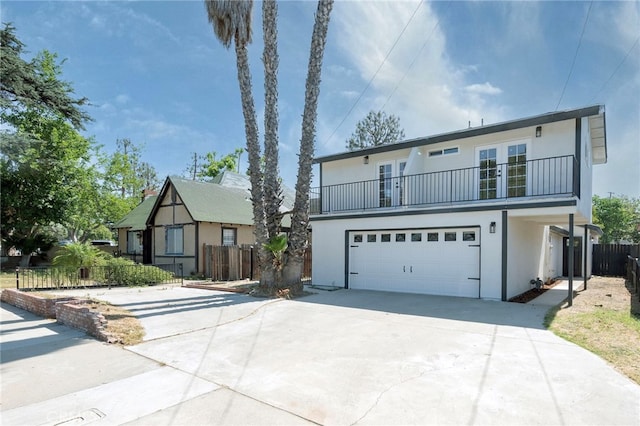 1478 N Park Ave, Pomona, CA 91768 - view of front facade featuring french doors, a balcony, concrete driveway, and stucco siding