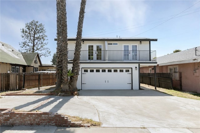 1478 N Park Ave, Pomona, CA 91768 - traditional-style house with french doors, a balcony, driveway, an attached garage, and stucco siding