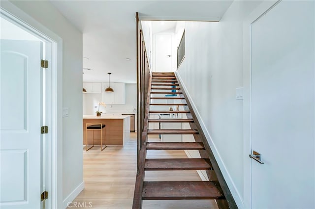 1478 N Park Ave, Pomona, CA 91768 - staircase featuring wood finished floors and baseboards