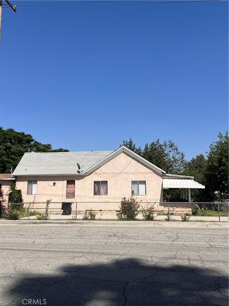 207 E O St, Colton, CA 92324 - ranch-style house with a fenced front yard and stucco siding
