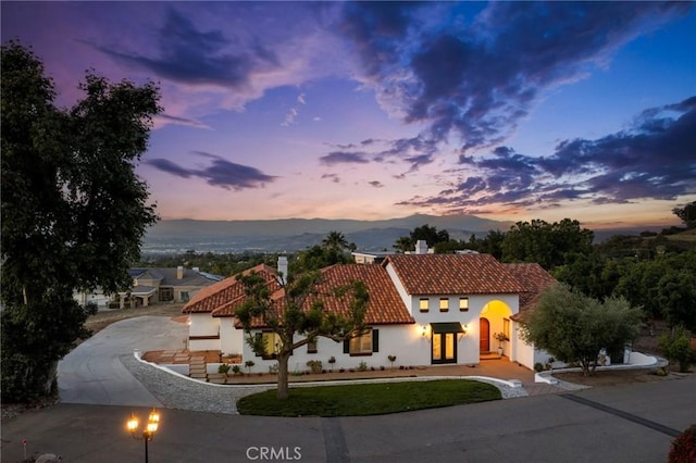 4368 Crown Ranch Rd, Corona, CA 92881 - mediterranean / spanish-style home with a tile roof, curved driveway, a chimney, and stucco siding