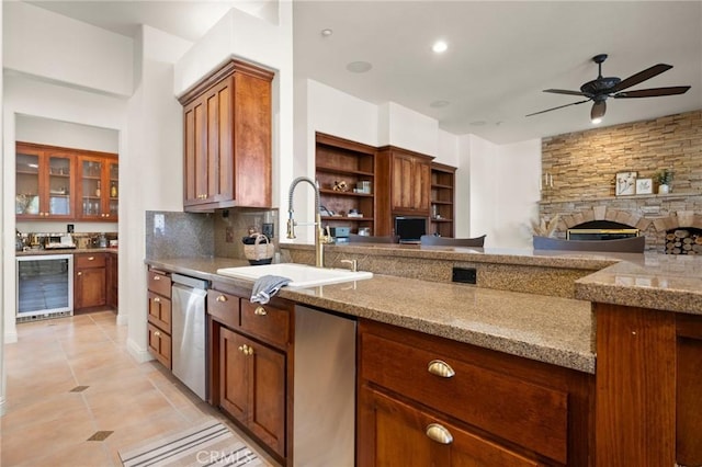 4368 Crown Ranch Rd, Corona, CA 92881 - kitchen featuring wine cooler, stainless steel dishwasher, light stone countertops, and brown cabinetry