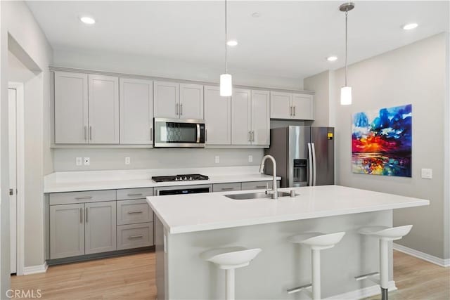 27753 Dyer Way, Canyon Country, CA 91387 - kitchen with stainless steel appliances, light wood-style flooring, light countertops, a kitchen breakfast bar, and recessed lighting