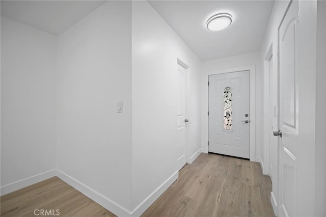 7848 Chastain Ave, Reseda, CA 91335 - doorway to outside featuring light wood-style floors and baseboards