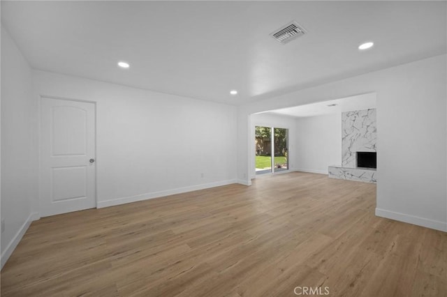 7848 Chastain Ave, Reseda, CA 91335 - unfurnished living room with light wood-type flooring, a fireplace, and recessed lighting