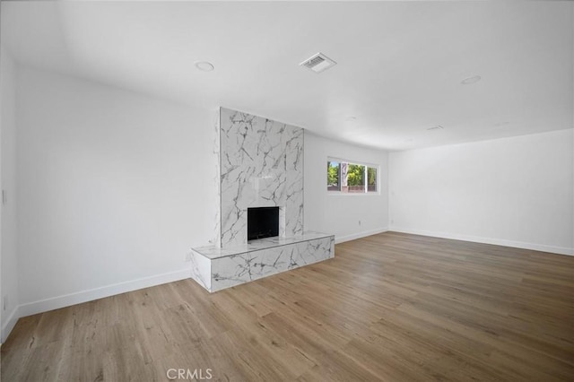 7848 Chastain Ave, Reseda, CA 91335 - unfurnished living room featuring a high end fireplace and wood finished floors