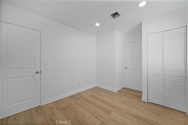 7848 Chastain Ave, Reseda, CA 91335 - unfurnished bedroom with light wood-style floors, a closet, and recessed lighting