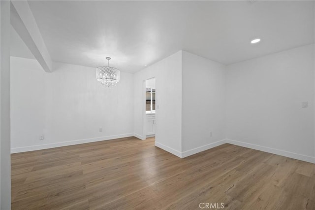 7848 Chastain Ave, Reseda, CA 91335 - unfurnished room featuring a chandelier, wood finished floors, and recessed lighting