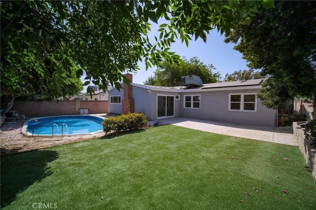 7848 Chastain Ave, Reseda, CA 91335 - rear view of house featuring stucco siding, a fenced backyard, a chimney, and a patio