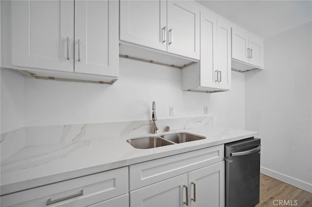 7848 Chastain Ave, Reseda, CA 91335 - kitchen featuring dishwasher, white cabinets, light wood finished floors, and light stone countertops