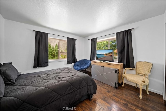 42903 Normandy Ln, Lancaster, CA 93536 - bedroom featuring multiple windows, wood finished floors, and a textured ceiling
