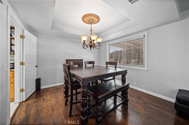 42903 Normandy Ln, Lancaster, CA 93536 - dining room featuring a chandelier, wood finished floors, and a tray ceiling