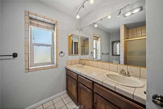 42903 Normandy Ln, Lancaster, CA 93536 - full bath featuring double vanity, a shower with door, and tile patterned flooring