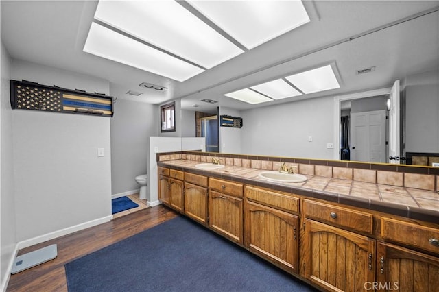 42903 Normandy Ln, Lancaster, CA 93536 - bathroom featuring double vanity and wood finished floors